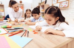 Children write in notebooks with a pen. Children write in notebooks with a pen.