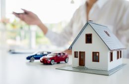Car and House model with agent and customer discussing for contr Car and House model with agent and customer discussing for contract to buy, get insurance or loan real estate or property background.