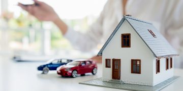 Car and House model with agent and customer discussing for contract to buy, get insurance or loan real estate or property background.